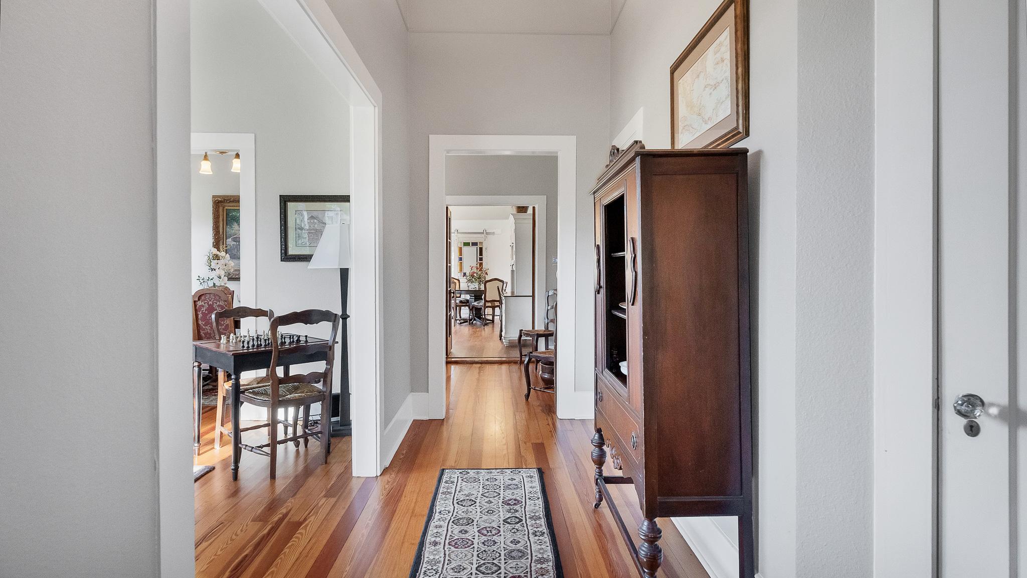 Living area photo showing historic trim and windows at 1305 S College St