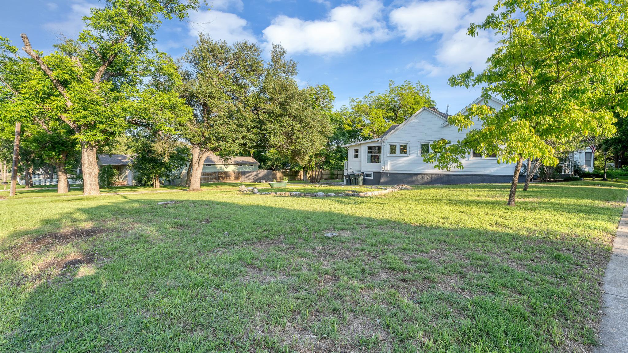 Large yard and exterior view at 1301 and 1305 S College St in Georgetown Texas
