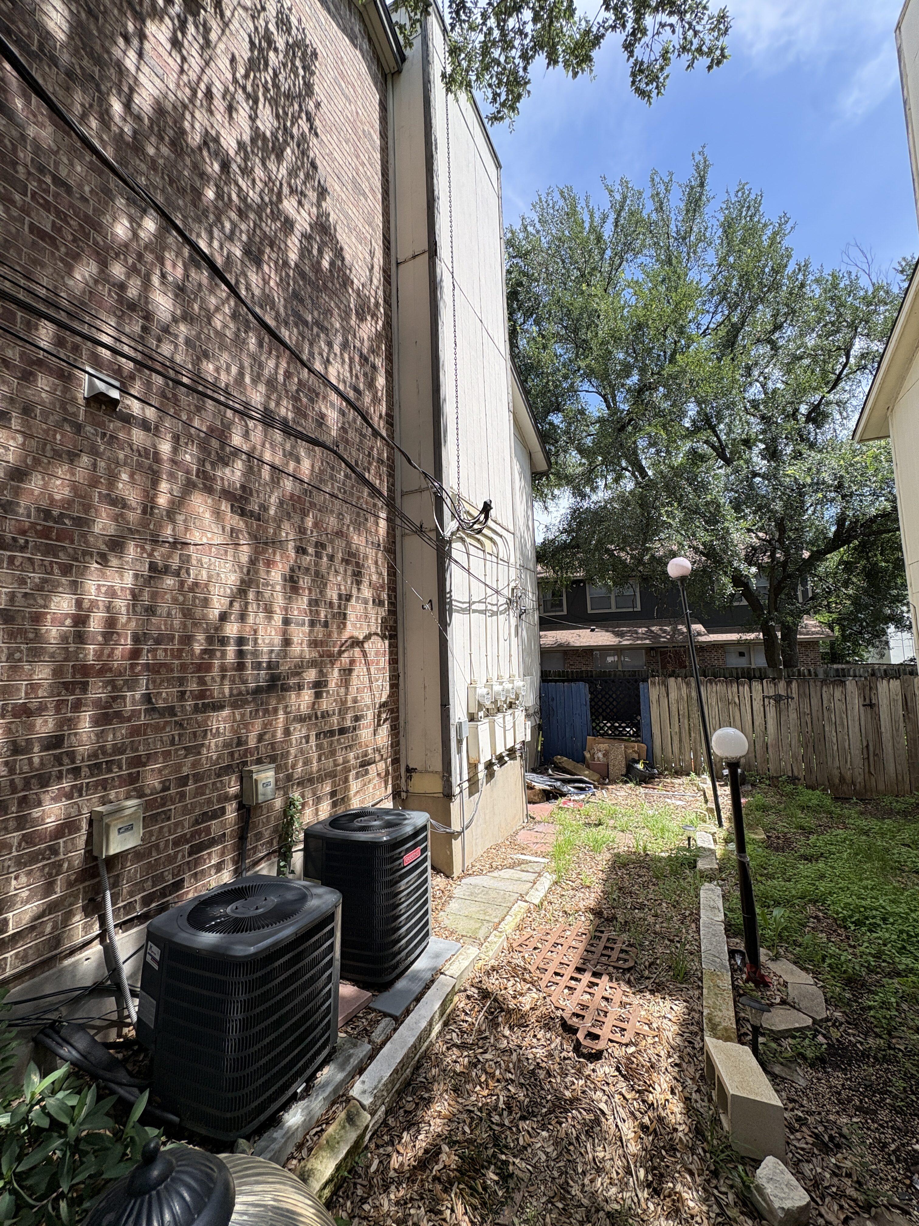 Side exterior with HVAC equipment and yard area at 4312 Acropolis Ct Austin Texas