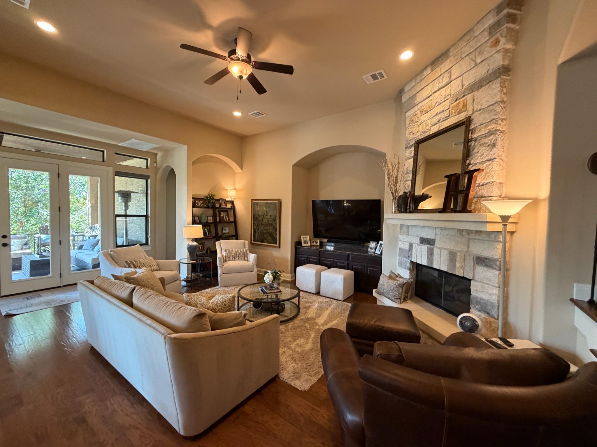 Living room with stone fireplace at 410 Indianwood Dr